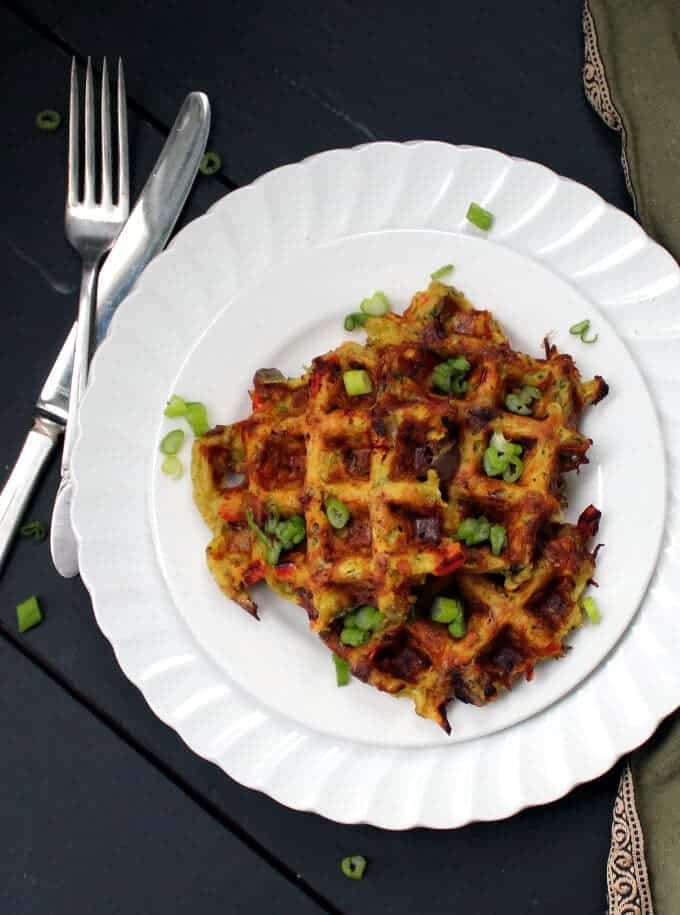 Vegan Hash Brown Waffles in white plate with knife and fork.