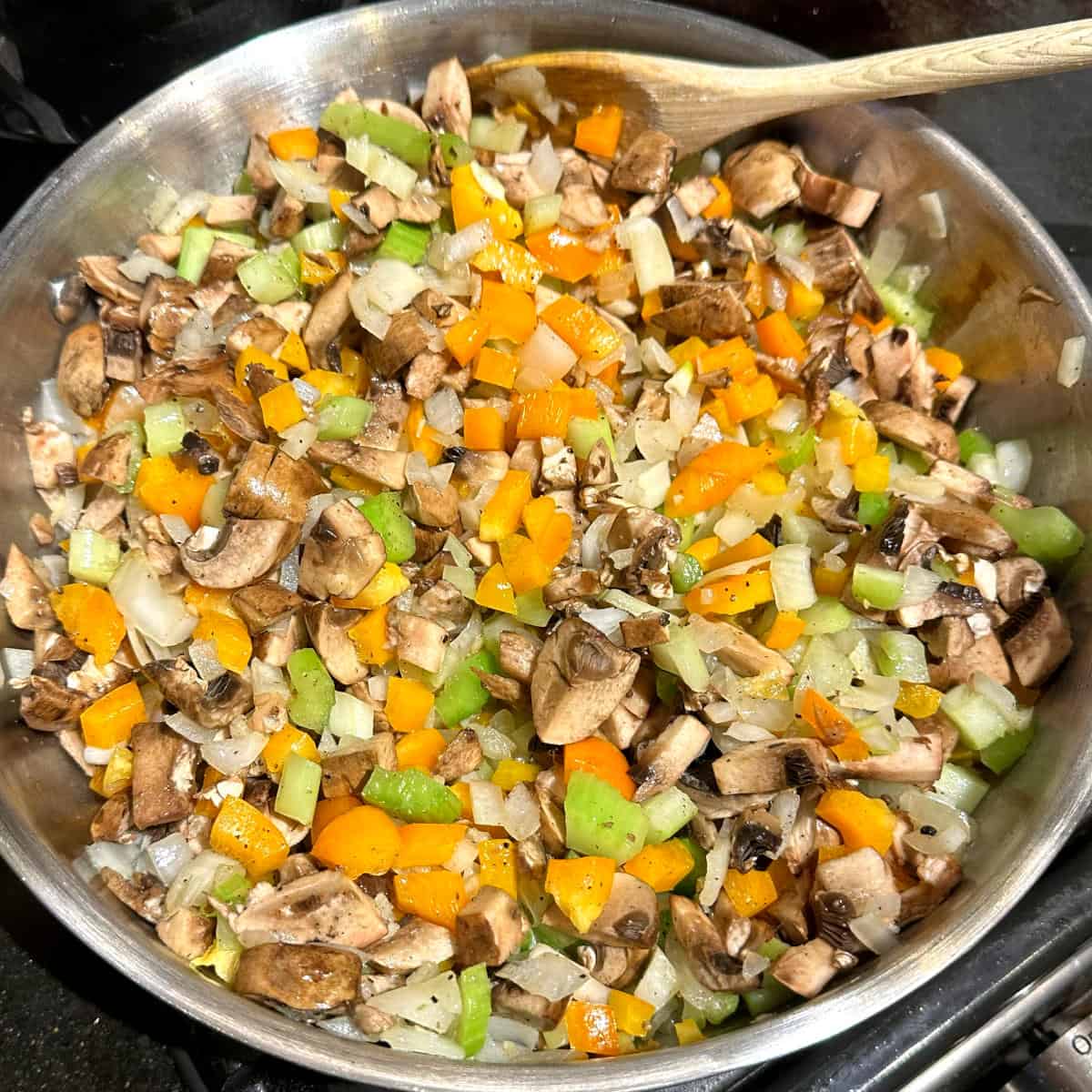 Mushrooms added to other veggies in skillet.
