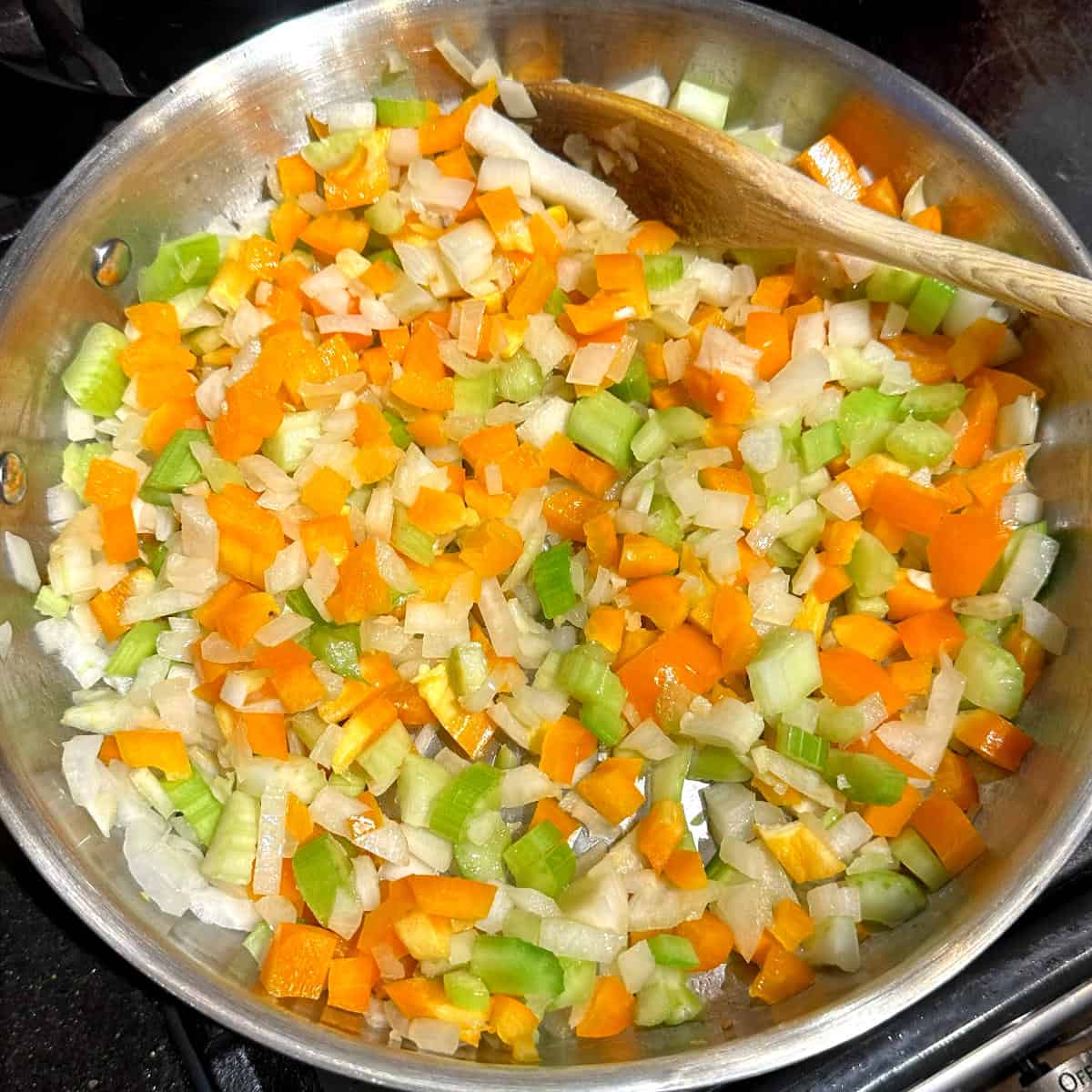 Carrots and bell peppers added to skillet.