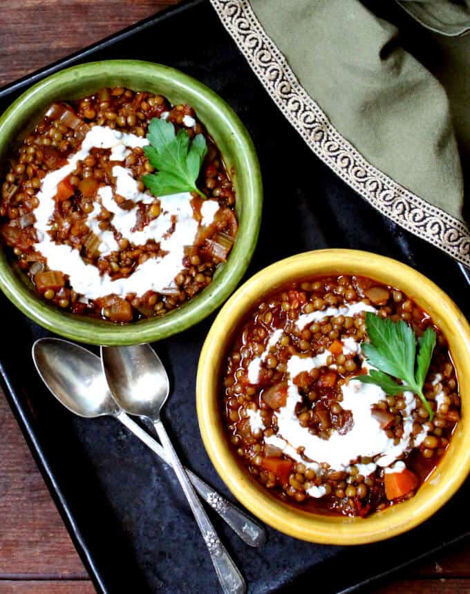 Creamy Lentils Spiced with Ancho in bowls with spoons.