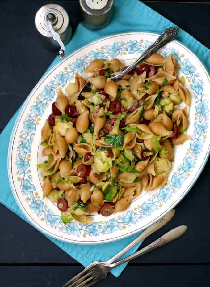 Speedy Pasta with Brussels Sprouts and Olives in blue and white platter on blue napkin.