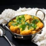 This Cauliflower Curry with Potatoes is a beautiful way to showcase this versatile Fall vegetable. Indian spices add depth and flavor, and tons of deliciousness. Serve with rice, roti or bread. A vegan, soy-free, gluten-free and nut-free recipe. #vegan #soyfree #nutfree #glutenfree #cauliflower #indian #curry HolyCowVegan.net