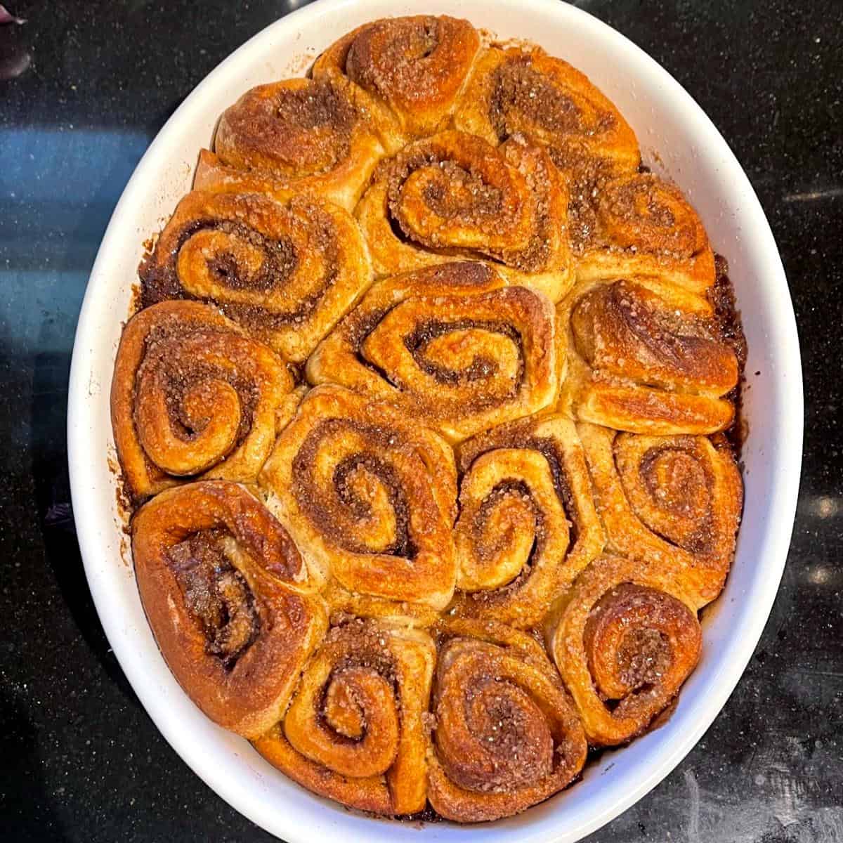 Sourdough sticky buns after baking in oval baking dish.