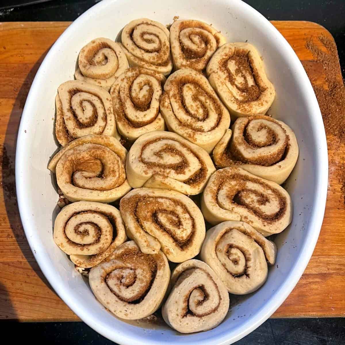 Sourdough sticky buns in oval baking dish.
