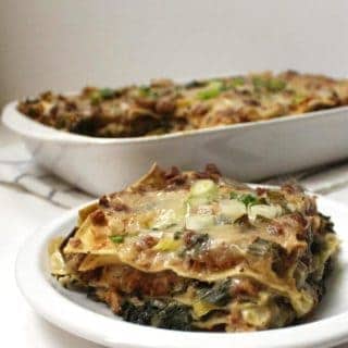 A creamy Vegan Sausage Breakfast Lasagna is the perfect start to a day. It's layered with veggies like spinach, leeks and scallions, and all of this goodness is smothered in a dreamy bechamel sauce. #vegan #breakfast #lasagna HolyCowVegan.net