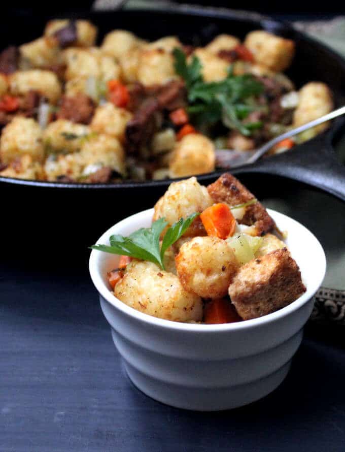 The secret to my perfect Vegan Thanksgiving Stuffing is crunchy, crispy tater tots. This traditional holiday staple gets a fresh, new makeover in a recipe that's as easy and fun to make as it is delicious to eat. Vegan, nut-free, soy-free and can be gluten-free. #vegan #soyfree #nutfree #thanksgiving #sidedish #stuffing HolyCowVegan.net