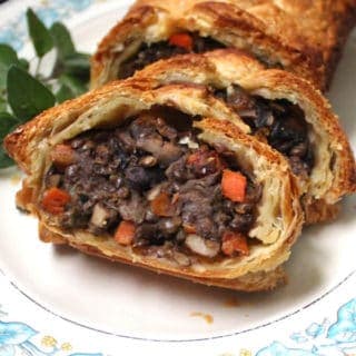 This gorgeous Vegan Wellington with Mushrooms and Lentils will have everyone gawking -- and gorging -- at your holiday table. It tastes just as good as it looks, with meaty lentils and mushrooms tied together by a mirepoix of onions, carrots and celery and infused with fresh herbs. A vegan, nut-free recipe. #vegan #thanksgiving #holidayrecipes #nutfree #kidfriendly HolyCowVegan.net