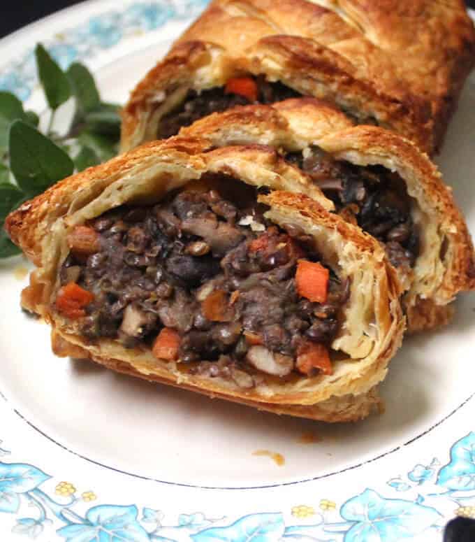 This gorgeous Vegan Wellington with Mushrooms and Lentils will have everyone gawking -- and gorging -- at your holiday table. It tastes just as good as it looks, with meaty lentils and mushrooms tied together by a mirepoix of onions, carrots and celery and infused with fresh herbs. A vegan, nut-free recipe. #vegan #thanksgiving #holidayrecipes #nutfree #kidfriendly HolyCowVegan.net
