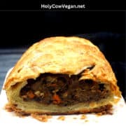 Vegan wellington loaf on marble board with text that says "vegan wellington with mushrooms and lentils".