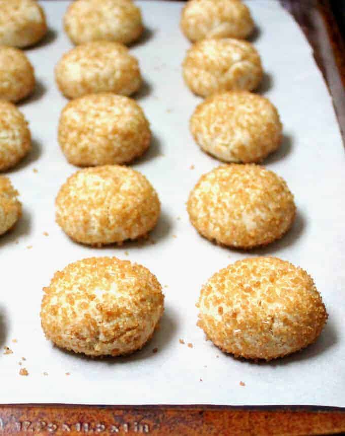 Vegan and gluten-free Italian Amaretti Cookies on baking sheet lined with parchment paper.