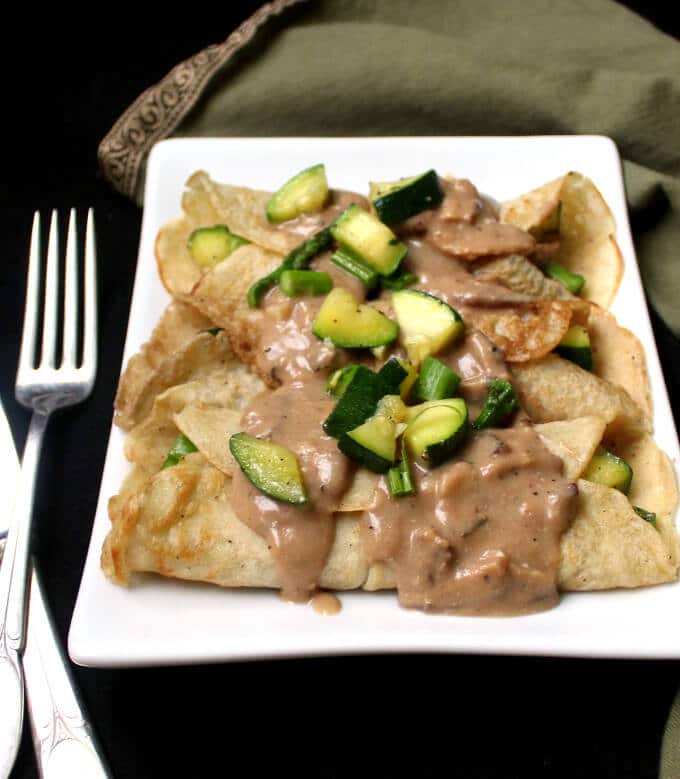 Savory Vegan Crepes with Mushroom Sauce in white plate.