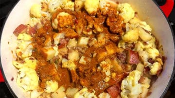 Tomato sauce poured over cauliflower and potatoes.