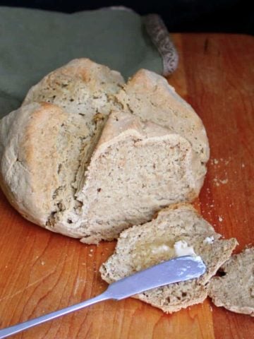 This vegan gluten-free Irish Soda Bread is as classic and traditional as this bread can get, only with a modern, healthy twist. The bread has a dense texture, a soft and tender crumb, and there's nothing quite as delicious as a warm, hot-off-the-oven slice slathered with vegan butter. #stpatricksday #irishrecipe #vegan #bread #irish #breakfast #glutenfree HolyCowVegan.net