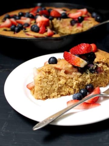 A glutenfree vegan Skillet Cornbread Cake that's golden and tender and delicious, with fresh berries baked in. #vegan #glutenfree #nutfree #soyfree #cake #mothersday HolyCowVegan.net
