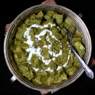 A delicious and healthy recipe for Aloo Palak, a spinach and potato curry, made in under 20 minutes with my basic tomato onion sauce. #vegan #indianfood #dinnerrecipe #spinach #potatoes HolyCowVegan.net