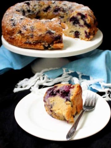 This vegan Blueberry Buttermilk Cake has a light yet moist crumb, hints of lemon and purple streaks of gooey, baked blueberries. #blueberries #cake #spring #dessert HolyCowVegan.net