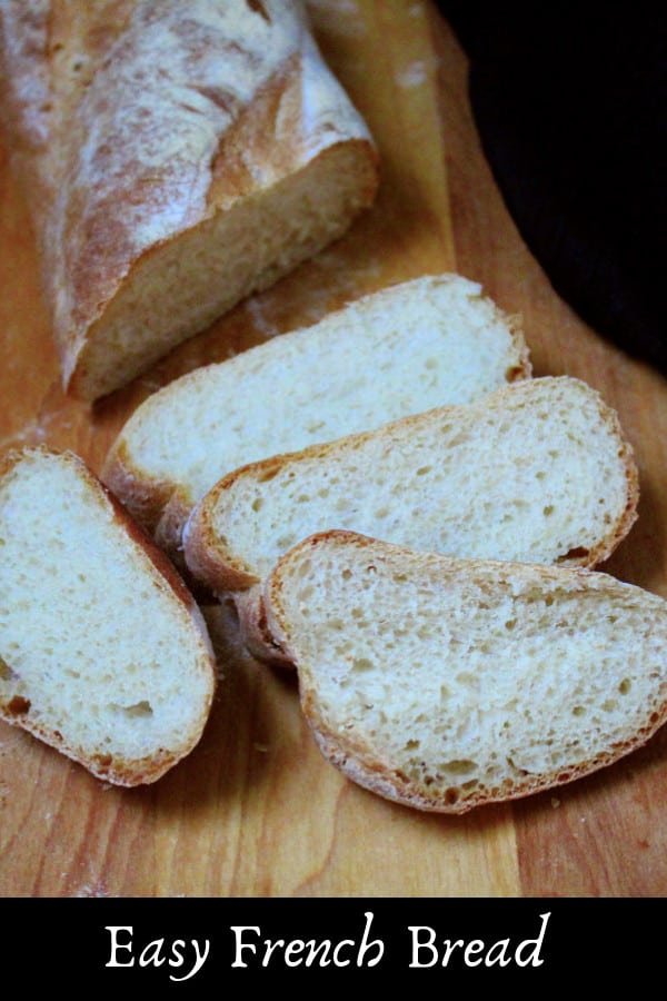 Easy French Bread, sliced, on chopping board.