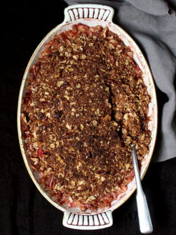 A vegan rhubarb crisp that is easy as pie to make. A gooey, jelly-like, tart rhubarb filling is topped with a golden, delicious, oat and nut crisp. Can be a gluten-free recipe. Perfect for breakfast or dessert.