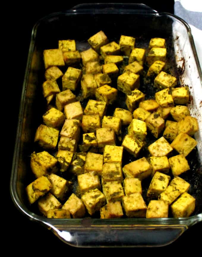 Baked tofu cubes in a glass baking dish.