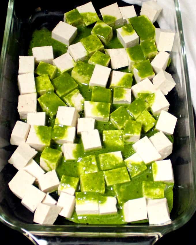 Tofu cubes with marinade poured over them.