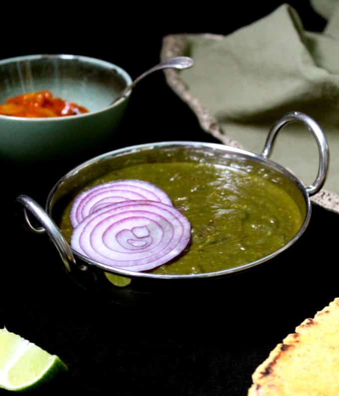 A frontal shot of a bowl of sarson ka saag, a mustard greens curry