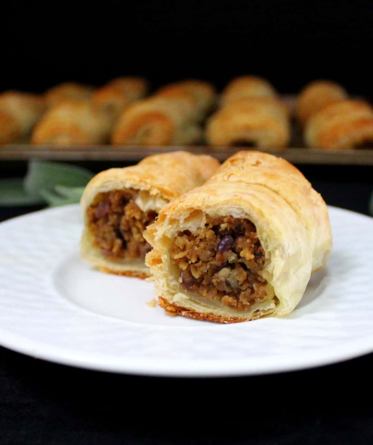 Meatless sausage rolls on a white plate
