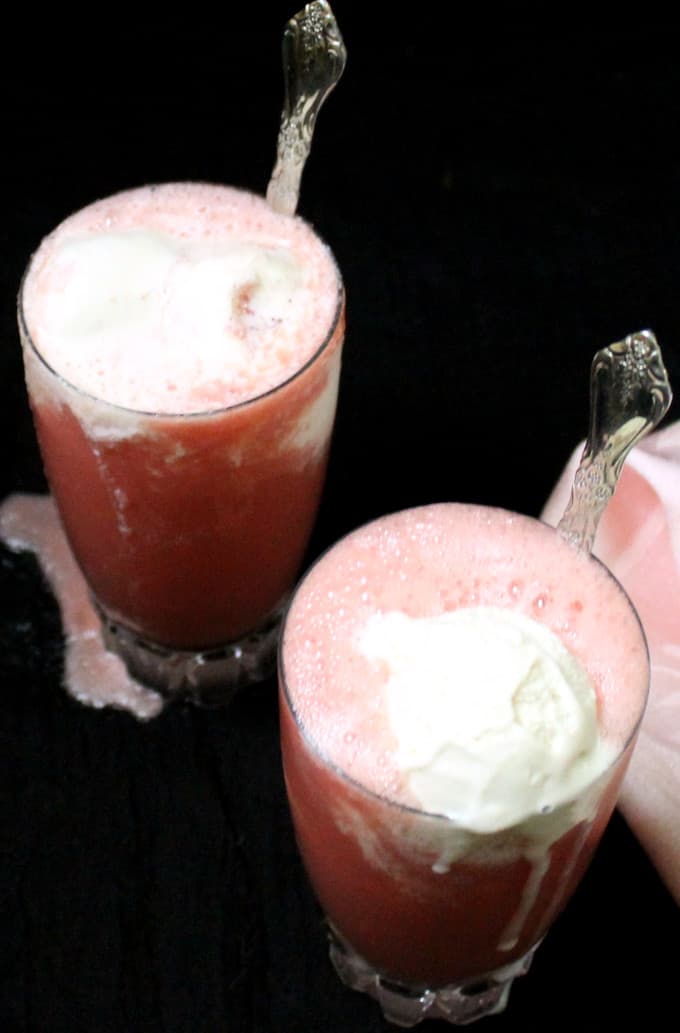 Watermelon smoothie topped with vegan ice cream in tall glasses.