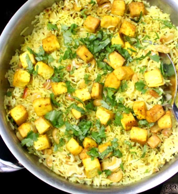 Lemon Garlic Rice in a steel pan garnished with cilantro and with tofu cubes