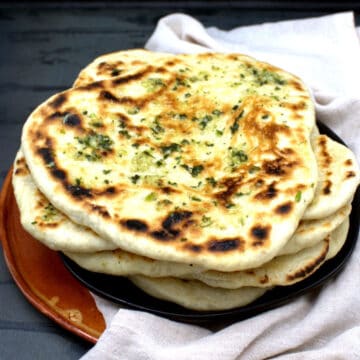Vegan naan on plate with garlic butter topping.