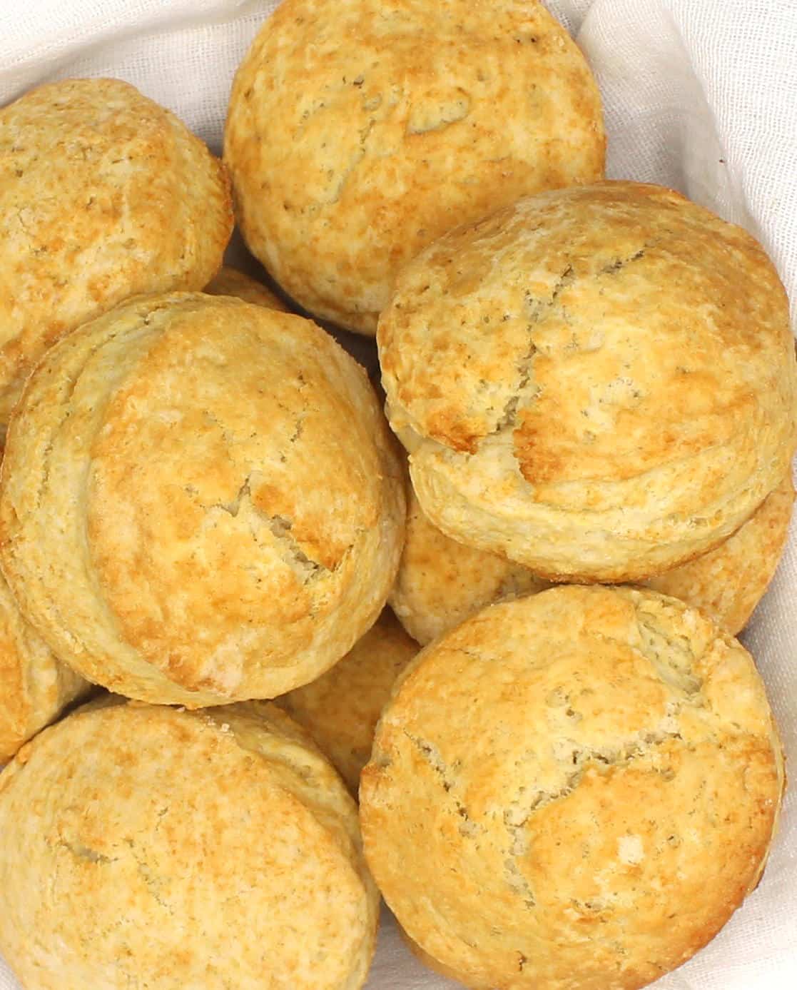 Fluffy vegan biscuits nestling in white kitchen napkin.