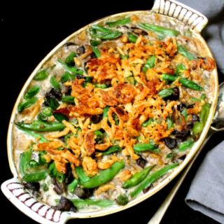A top shot of a vegan green bean casserole in a yellow and white old-fashioned casserole dish