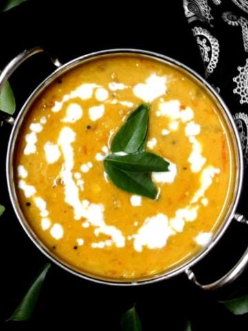 Top shot of a bowl of creamy red lentil dhal with coconut milk