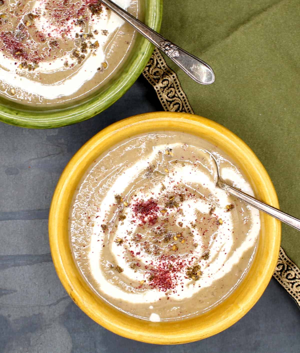 Eggplant soup in bowls with cashew cream and za'atar.