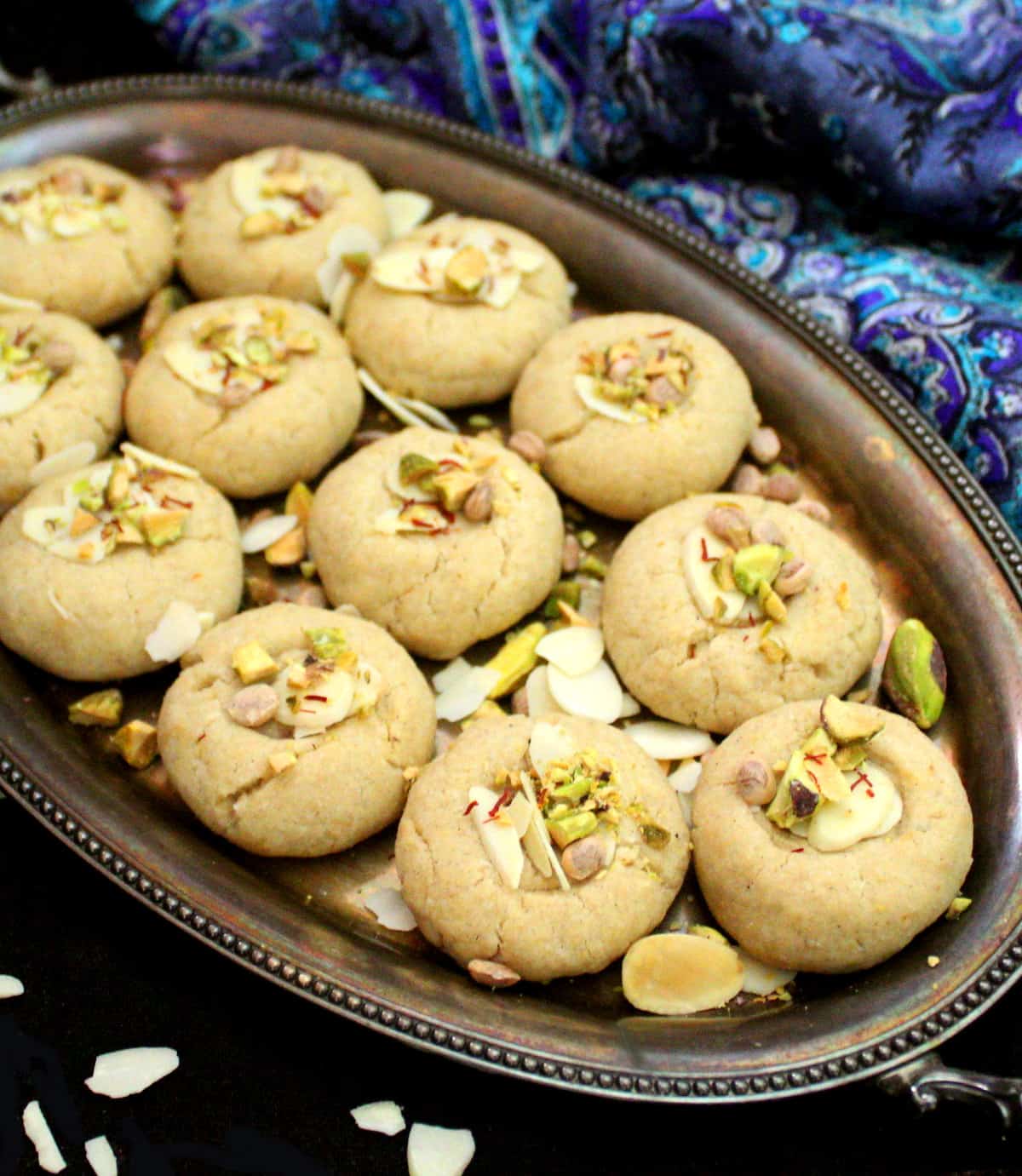 A tray with vegan nankhatai cookies studded with nuts.