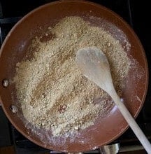 Besan or chickpea flour being toasted in skillet.
