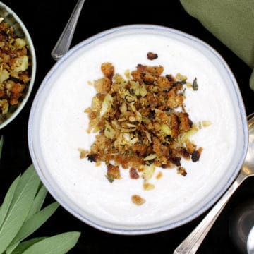 Make this creamy vegan Cauliflower soup with a crunchy and herby breadcrumb topping to satisfy that urge for something warm and comforting in your belly as the leaves turn brown and the weather begins to bite. A soy-free recipe, can be nut-free and gluten-free. #vegan, #soup, #cauliflower, #glutenfree | HolyCowVegan.net