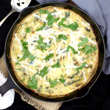 Here's a simple vegan Leek and Spinach Frittata with fresh leeks and spinach wrapped in a savory, creamy, herby custard of tofu and vegan cheese. It's a delicious, protein-packed meal you can devour any time of day. A nut-free and gluten-free recipe. #vegan, #frittata, #eggless, #veggies | HolyCowVegan.net
