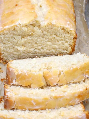 Sliced vegan lemon pound cake with soft, tender, dense crumb.