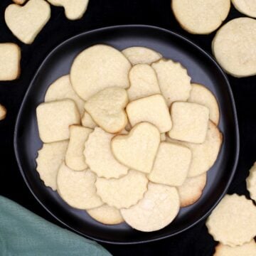 Vegan sugar cookies in black plate.
