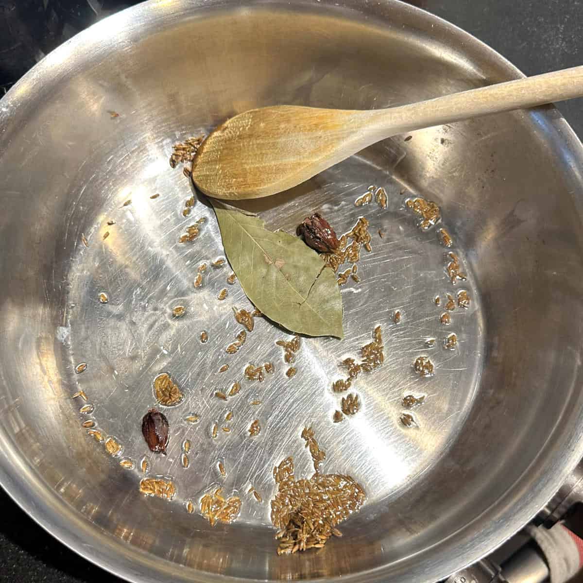 Photo of spices frying in oil.