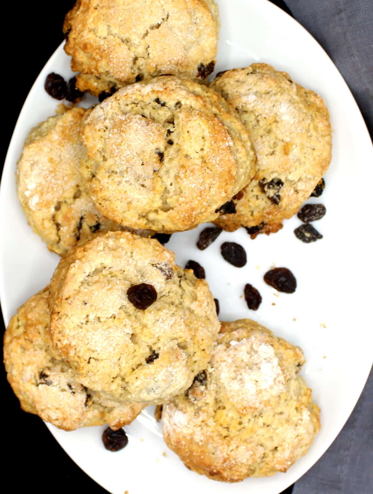 Round scones that are vegan and dairyfree on a plate with currants.