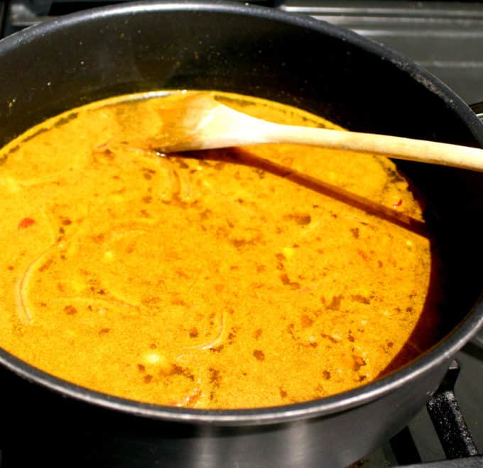 Sauce for vegan Jamaican curry cooking in saucepan.