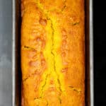 A loaf of vegan cardamom turmeric cake in loaf pan