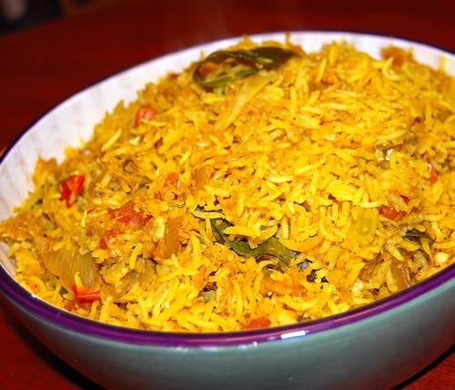 Photo of cabbage rice in a green and white bowl.