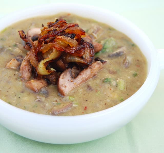Mushroom dal with caramelized mushrooms in a white bowl.