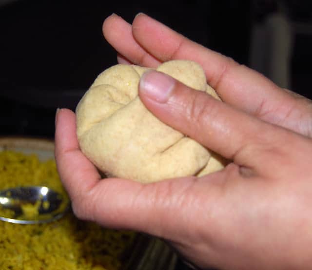 Wrapping the dough around the cauliflower filling.
