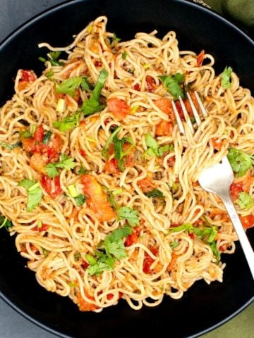 Photo of chilli garlic ramen noodles in a black bowl