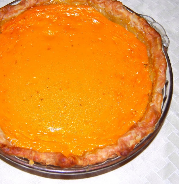 Photo of a vegan mango pie in a glass baking dish.