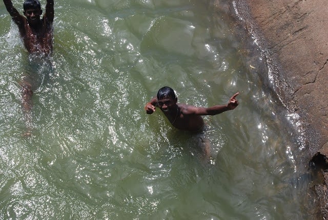A boy does the bolt while swimming in a canal near Madurai.