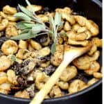Vegan Sage Butter Gnocchi pasta in a pan with wooden spoon